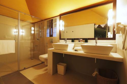 a bathroom with two sinks and a shower at Ajit Bhawan - A Palace Resort in Jodhpur