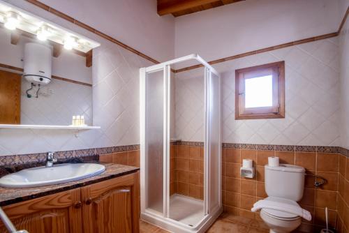 a bathroom with a shower and a toilet and a sink at Aguamar - Emar Hotels in Playa Migjorn