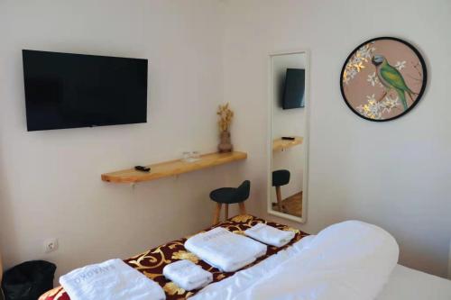 a bedroom with a bed with towels on it at Pension MOYCHI in Bled