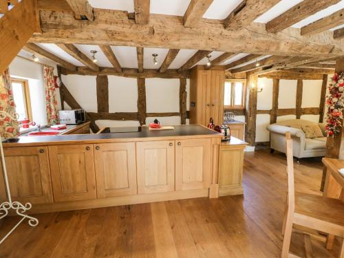 a kitchen with wooden walls and wooden floors at Manor Cottage in Church Stretton