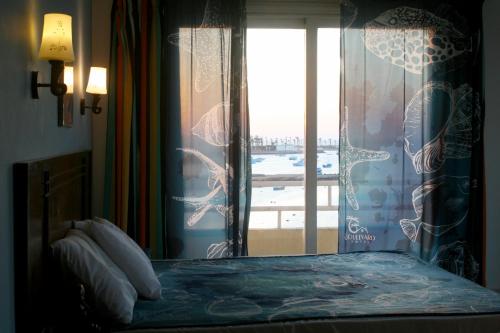 a bedroom with a bed and a window at Boulevard Apartment Hotel in Hurghada