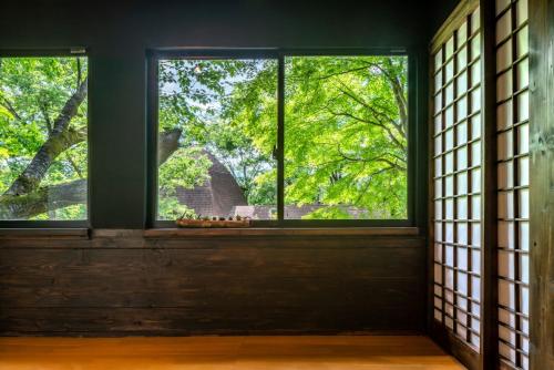 a window in a room with trees outside at 森の宿り 那須別邸まるやま in Nasu