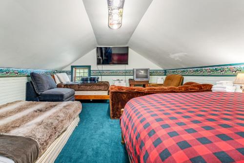 a bedroom with two beds and a couch and a tv at Roxbury Retreat in Roxbury