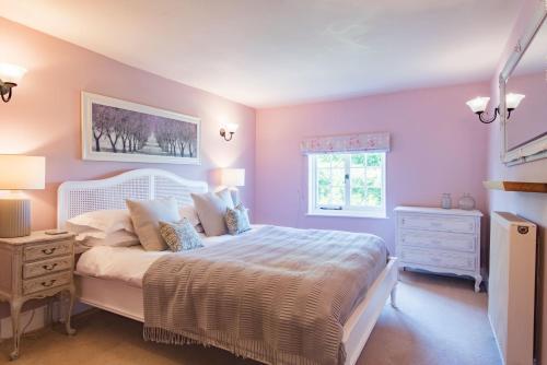 a bedroom with a large white bed and a window at The Old Post Office by Bloom Stays in Faversham