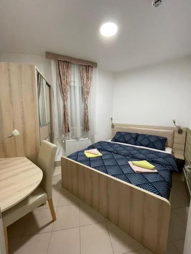 a bedroom with a bed with two yellow pillows on it at Holiday Wing Apartment 2 in Jagodina