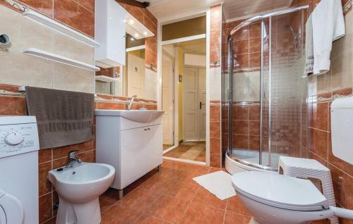 a bathroom with a toilet and a sink and a shower at Holiday home Sunny Dalmatia in Mratovo