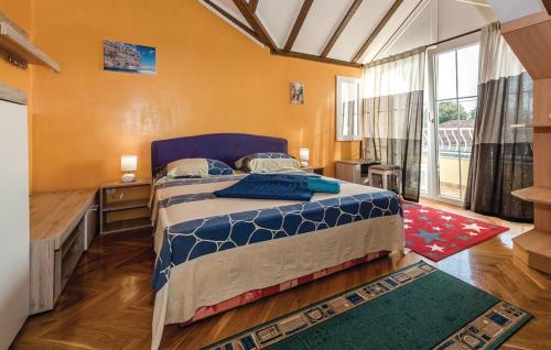 a bedroom with a bed and a large window at Holiday home Sunny Dalmatia in Mratovo
