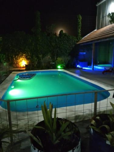 a swimming pool at night with green illumination at El Jacal de San Pedro in San Pedro