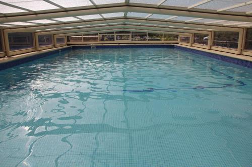 a large swimming pool with blue water at chambres d hotes Le Mas Julien piscine chauffée adult only in Orange