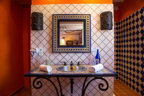 a bathroom with a sink and a mirror at chambres d hotes Le Mas Julien piscine chauffée adult only in Orange