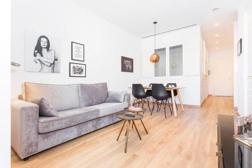 a living room with a couch and a table at Cozy Apartment close to Passeig de Gracia in Barcelona