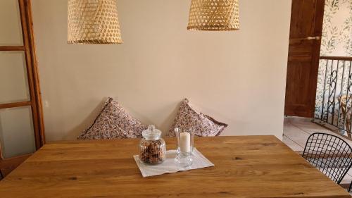 a wooden table with two candles on top of it at Casa Mon in Tiurana