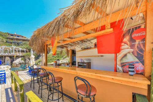 a bar with chairs at a restaurant on the beach at Atalante Hotel in Kas