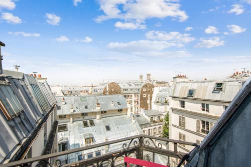 a view of a city from a balcony at Artist workshop with terrace on Paris roofs close to Montmartre - Welkeys in Paris