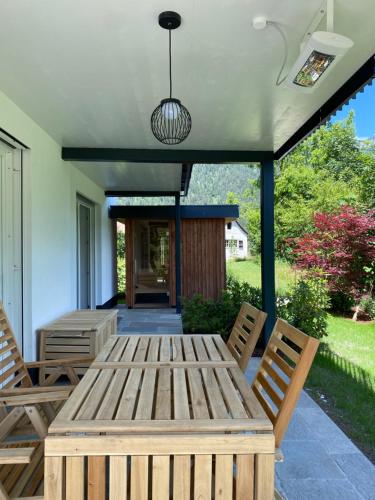 a wooden table and chairs on a patio at Apartment Steinplatte in Waidring