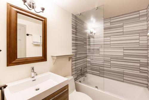 a bathroom with a sink and a toilet and a shower at Convenience and Style, Two Q Beds in Vail