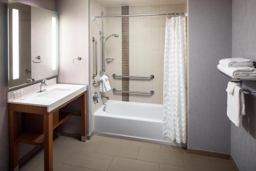 a bathroom with a tub and a sink and a shower at Hyatt Place Nashville Downtown in Nashville