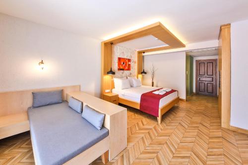a hotel room with a bed and a couch at Atalante Hotel in Kas