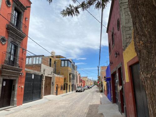 an empty street in an old town with buildings at Nunõ in San Miguel de Allende