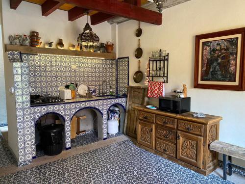 a kitchen with a stove and a fireplace at Nunõ in San Miguel de Allende