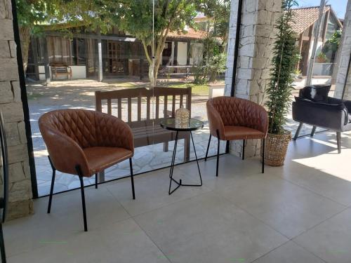 two chairs and a table on a patio at Deck de Búzios in Búzios