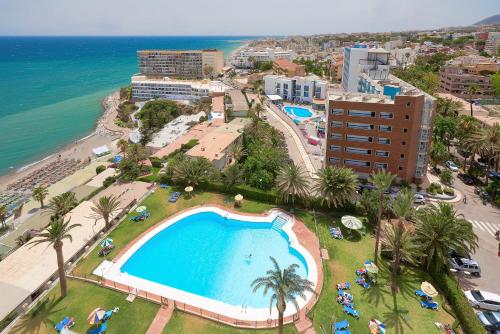 an aerial view of a resort with a swimming pool and the ocean at PURA VIDA Luxury apartment with jacuzzi in Torremolinos