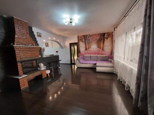 a living room with a couch and a fireplace at Casa Dor de Lac in Salcioara