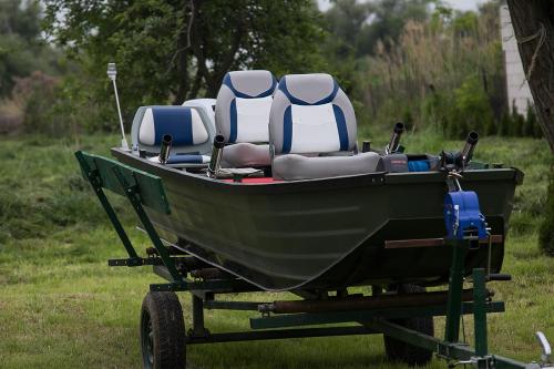 a small boat on a trailer in a field at Agropensiunea Beluga in Gorgova