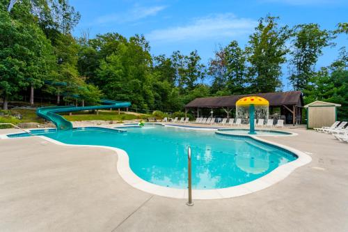 a swimming pool with a slide in a park at Drummer Boy Camping Resort in Gettysburg