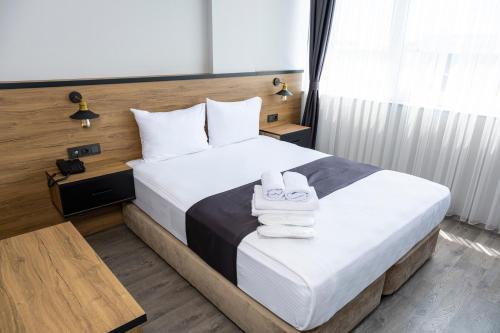 a hotel room with a bed with towels on it at Comfort Center Suit Hotel in Edirne