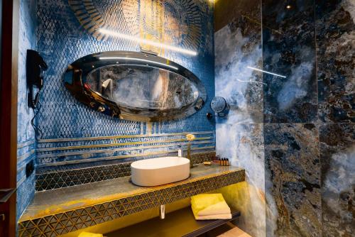 a bathroom with a sink and a mirror at Tapis Rouge Design Boutique Hotel in Batumi