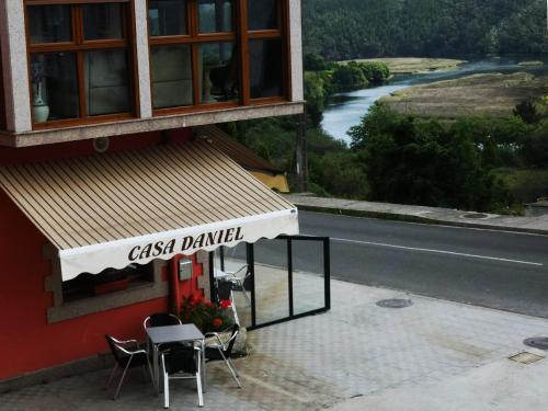 a restaurant with a sign on the side of a building at Casa Daniel in Riberas del Sor