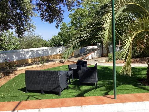 a group of chairs sitting on a lawn at Quinta da Horta Nova in Elvas