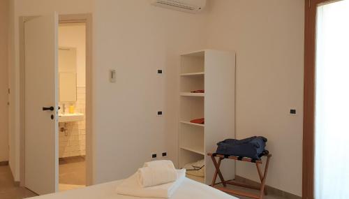 una habitación con una cama y una bolsa azul en una silla en Anima Franca Bed and breakfast, en Greve in Chianti