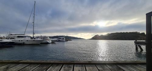 a group of boats docked at a dock on a lake at Marinan Richters in Fjällbacka