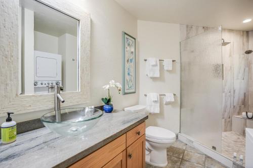 a bathroom with a glass bowl sink and a shower at Pali Ke Kua 113 in Princeville