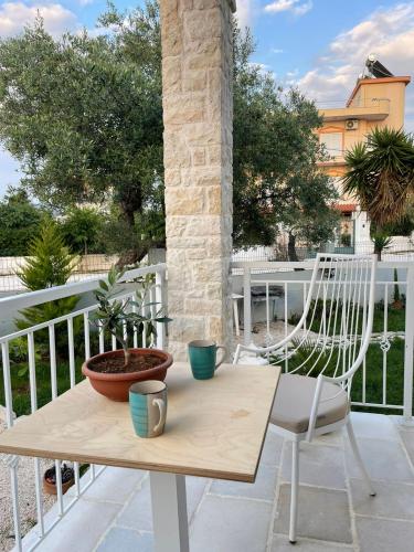 a table and chairs on a balcony with a table and chairs at Tani's House in Sarandë