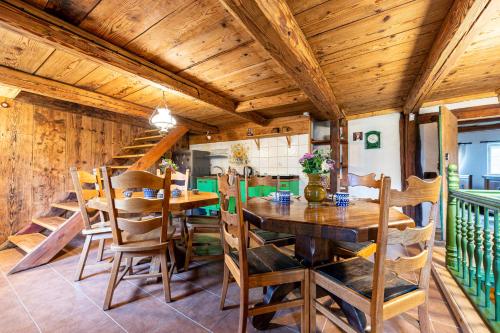 a dining room with a wooden table and chairs at Dom pod Mandragorą in Świeradów-Zdrój