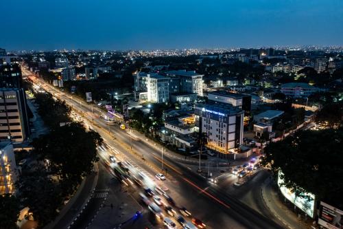 a city at night with traffic on a highway at Airport View Hotel in Accra