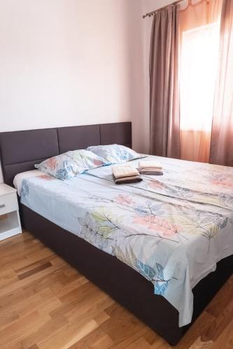 a bed with two books on it in a bedroom at Apartments Time For Sea in Koper