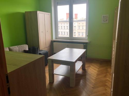a small room with a table and a window at Blue River - Plac Legionow in Wrocław