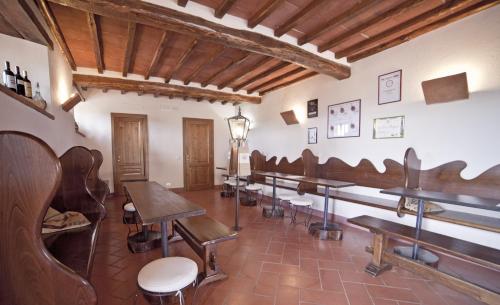 a row of tables and chairs in a room at Castello Vicchiomaggio in Greve in Chianti