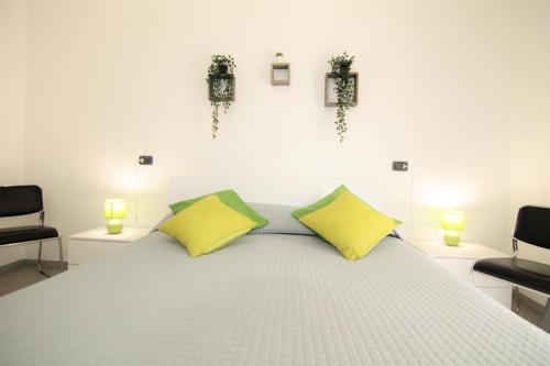 a bedroom with a large bed with two yellow pillows at [Matteottinove] in Pescara
