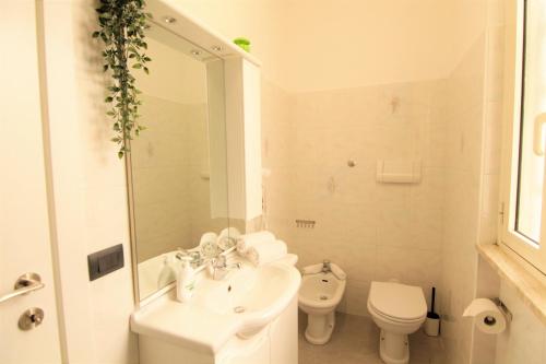 a white bathroom with a sink and a toilet at [Matteottinove] in Pescara