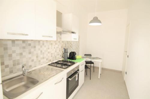 a kitchen with a sink and a stove top oven at [Matteottinove] in Pescara