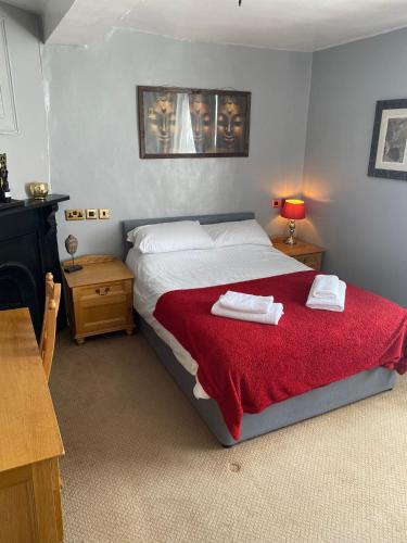 a bedroom with a bed with two towels on it at The Angel Inn Stourport in Stourport