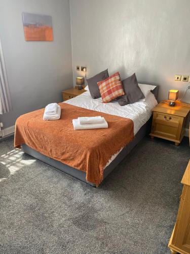 a bedroom with a bed with two towels on it at The Angel Inn Stourport in Stourport