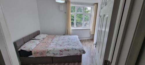a small bedroom with a bed and a window at VH Premier Flat 3 in Gillingham