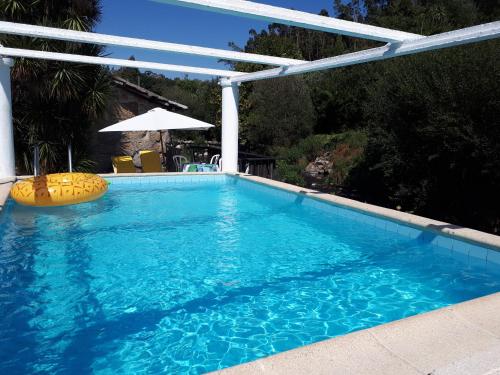 a swimming pool with a pergola and a swimming pool at Dream corner by waterfalls, 20 min to Oporto, by Porto with Love LDA in Parada