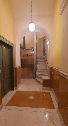 an empty hallway with stairs and a light fixture at Tacito Apartments in Terni
